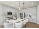 Stylish kitchen with a quartz island, white cabinetry, stainless steel appliances, and modern fixtures at 1849 Ballard Rd # Holly Georgian, Fuquay Varina, NC 27526