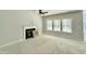Spacious living room with fireplace, large windows, and a ceiling fan at 1849 Ballard Rd # Holly Georgian, Fuquay Varina, NC 27526