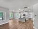 Open-concept living and kitchen area features hardwood floors, recessed lighting, and large windows at 1849 Ballard Rd # Holly Georgian, Fuquay Varina, NC 27526