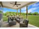 Covered patio with comfortable outdoor seating, ceiling fan, and scenic backyard view at 1849 Ballard Rd # Holly Georgian, Fuquay Varina, NC 27526