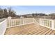 Spacious wooden back deck overlooks the large fenced in yard with shed and greenhouse at 20 Patterson Dr, Angier, NC 27501