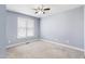 Spacious bedroom with neutral carpet, ceiling fan, and bright window at 20 Patterson Dr, Angier, NC 27501