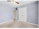 Bedroom featuring neutral carpet and dual closets, painted in a neutral palette at 20 Patterson Dr, Angier, NC 27501