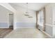 Bright dining area features large windows, stylish chandelier, and elegant two-tone wall design at 20 Patterson Dr, Angier, NC 27501