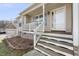 Welcoming front porch with white railings leading to the front door, set against a sunny blue sky at 20 Patterson Dr, Angier, NC 27501