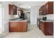 Well-equipped kitchen boasts granite counters, dark wood cabinetry, and modern stainless steel appliances at 20 Patterson Dr, Angier, NC 27501