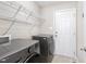 Well-lit laundry room with washer, dryer, and ample shelving at 20 Patterson Dr, Angier, NC 27501