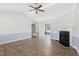 Bright living room featuring hardwood floors, a ceiling fan, and a cozy fireplace at 20 Patterson Dr, Angier, NC 27501