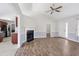 Open living room layout with a fireplace, hardwood floors, and an entryway to the kitchen at 20 Patterson Dr, Angier, NC 27501