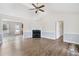 Spacious living room featuring hardwood floors, a fireplace, and an open layout to adjacent rooms at 20 Patterson Dr, Angier, NC 27501