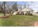 Quaint ranch-style home with a manicured lawn, and mature landscaping at 210 Long Crescent Dr, Durham, NC 27712