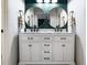 Bathroom vanity with double sinks, marble countertops, bronze fixtures, and a patterned floor at 2116 Leadenhall Way, Raleigh, NC 27603