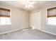 Bright bedroom featuring neutral walls, two windows with blinds, and a double door closet at 2116 Leadenhall Way, Raleigh, NC 27603