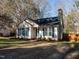 Charming one-story home featuring a manicured lawn, complemented by a vibrant blue front door and decorative shutters at 2116 Leadenhall Way, Raleigh, NC 27603