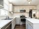 Well-lit kitchen with stainless steel appliances, gray cabinets, and white countertops at 2116 Leadenhall Way, Raleigh, NC 27603