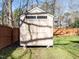 Backyard storage shed with double doors and small upper windows, set against a wooden fence at 2116 Leadenhall Way, Raleigh, NC 27603