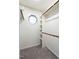 Organized walk-in closet with shelving, hanging rods, carpeted floor and small window at 2116 Leadenhall Way, Raleigh, NC 27603