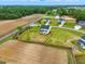 An aerial perspective displays houses with spacious, fenced yards bordering farmland, highlighting a blend of community and countryside at 22 Whistling Way # 18, Lillington, NC 27546