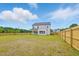 Large backyard surrounded by a wooden fence, providing a secure and private outdoor space at 22 Whistling Way # 18, Lillington, NC 27546