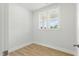 Bright, empty bedroom with two windows, wood-look floors, and white walls, ready for personalization at 22 Whistling Way # 18, Lillington, NC 27546