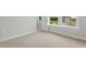 Bedroom with carpet, natural light from windows and an open door, providing a cozy and airy feel at 22 Whistling Way # 18, Lillington, NC 27546