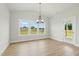Dining room with modern light fixture and a glass door with backyard views at 22 Whistling Way # 18, Lillington, NC 27546