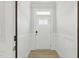 Clean, white entryway with wood-look floors and paneling, centered on a white door with glass at 22 Whistling Way # 18, Lillington, NC 27546
