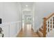 Bright entryway with white wainscoting, wood-look floors, and an open view to the living room and staircase at 22 Whistling Way # 18, Lillington, NC 27546