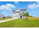 Elegant two-story white home boasting a lush green lawn and a driveway leading to a spacious two-car garage at 22 Whistling Way # 18, Lillington, NC 27546