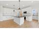 Spacious kitchen with white cabinets, an island with a sink, and stainless steel appliances at 22 Whistling Way # 18, Lillington, NC 27546