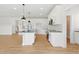 Modern white kitchen with island, stainless steel appliances, and stylish black hardware at 22 Whistling Way # 18, Lillington, NC 27546
