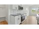 Close up of kitchen area with stainless steel appliances, white cabinets, and geometric tile backsplash at 22 Whistling Way # 18, Lillington, NC 27546