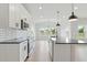 Open concept kitchen with stainless steel appliances, white cabinets, black countertops and breakfast bar at 22 Whistling Way # 18, Lillington, NC 27546