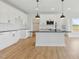 Bright kitchen featuring white cabinets, black countertops, large island, and stainless steel appliances at 22 Whistling Way # 18, Lillington, NC 27546