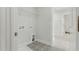 A well-lit laundry room with patterned tile flooring and a storage shelf at 22 Whistling Way # 18, Lillington, NC 27546