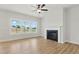Bright living room featuring a modern fireplace, ceiling fan, and large windows overlooking the backyard at 22 Whistling Way # 18, Lillington, NC 27546