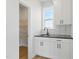 Convenient pantry with black countertop, sink, stylish backsplash, and open shelving for ample storage at 22 Whistling Way # 18, Lillington, NC 27546