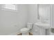 Neutral half-bathroom featuring a pedestal sink and a modern toilet, offering a clean and functional design at 22 Whistling Way # 18, Lillington, NC 27546