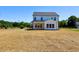 Back view of home with ample yard space, perfect for outdoor entertaining at 22 Whistling Way # Holly Farmhouse, Lillington, NC 27546