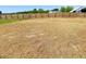 Large, newly seeded backyard ready for landscaping, offering privacy with a wood fence at 22 Whistling Way # Holly Farmhouse, Lillington, NC 27546