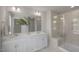 Sleek bathroom with double sinks, a large mirror, and glass-enclosed shower with built-in bench at 22 Whistling Way # Holly Farmhouse, Lillington, NC 27546