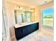 Bathroom with a dual vanity, large mirror, and outdoor view at 22 Whistling Way # Holly Farmhouse, Lillington, NC 27546