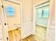 A half bathroom includes a window and white commode at 22 Whistling Way # Holly Farmhouse, Lillington, NC 27546