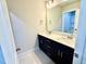 Modern bathroom featuring a double vanity with dark cabinetry and light countertops, tiled floors and an open shower at 22 Whistling Way # Holly Farmhouse, Lillington, NC 27546