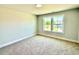Bedroom with carpeted floors and two large windows offering views of a neighboring house and the surrounding landscape at 22 Whistling Way # Holly Farmhouse, Lillington, NC 27546