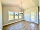 Dining room with backyard view and a chandelier at 22 Whistling Way # Holly Farmhouse, Lillington, NC 27546