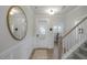 Elegant foyer featuring wainscoting, hardwood floors, staircase, and a view into other rooms at 22 Whistling Way # Holly Farmhouse, Lillington, NC 27546