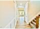 Hallway with staircase and wood flooring leads to a room with natural light at 22 Whistling Way # Holly Farmhouse, Lillington, NC 27546
