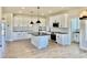Bright kitchen with an island, modern appliances, black countertops and pendant lights at 22 Whistling Way # Holly Farmhouse, Lillington, NC 27546