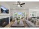 Bright living room featuring fireplace, ceiling fan, and large windows at 22 Whistling Way # Holly Farmhouse, Lillington, NC 27546